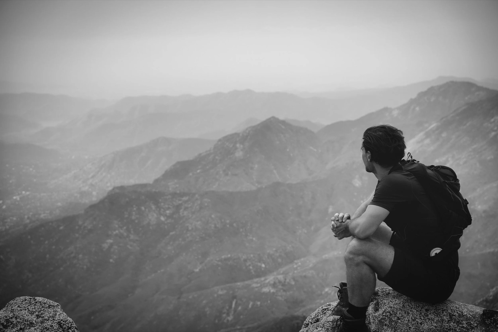 Johan Grönstedt looking out over a mountain range, alone with a thought